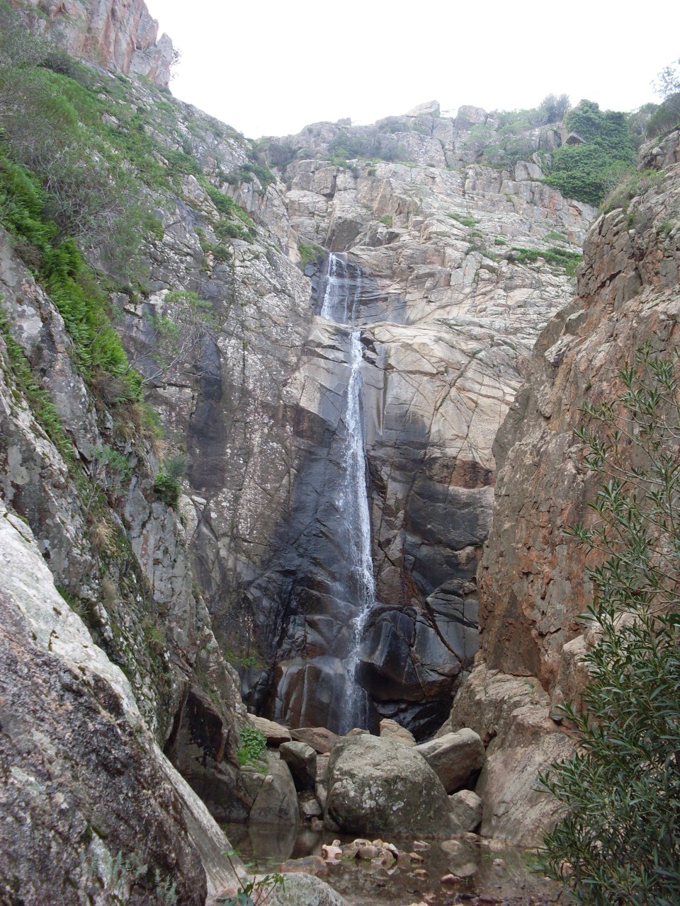 The steep granite gorge and base pool of Cascate di Sa Spendula in Sardinia